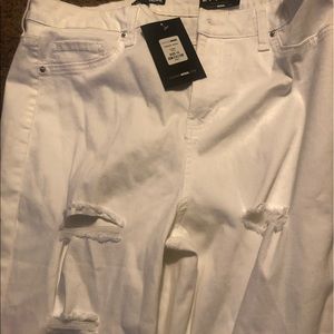 White ripped jeans with tags